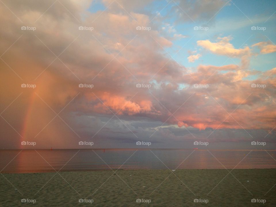 Sunset with rainbow over the Baltic Sea coast in Poland 