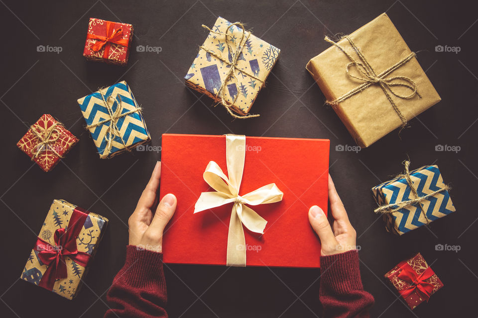 Hands holding present box, top view