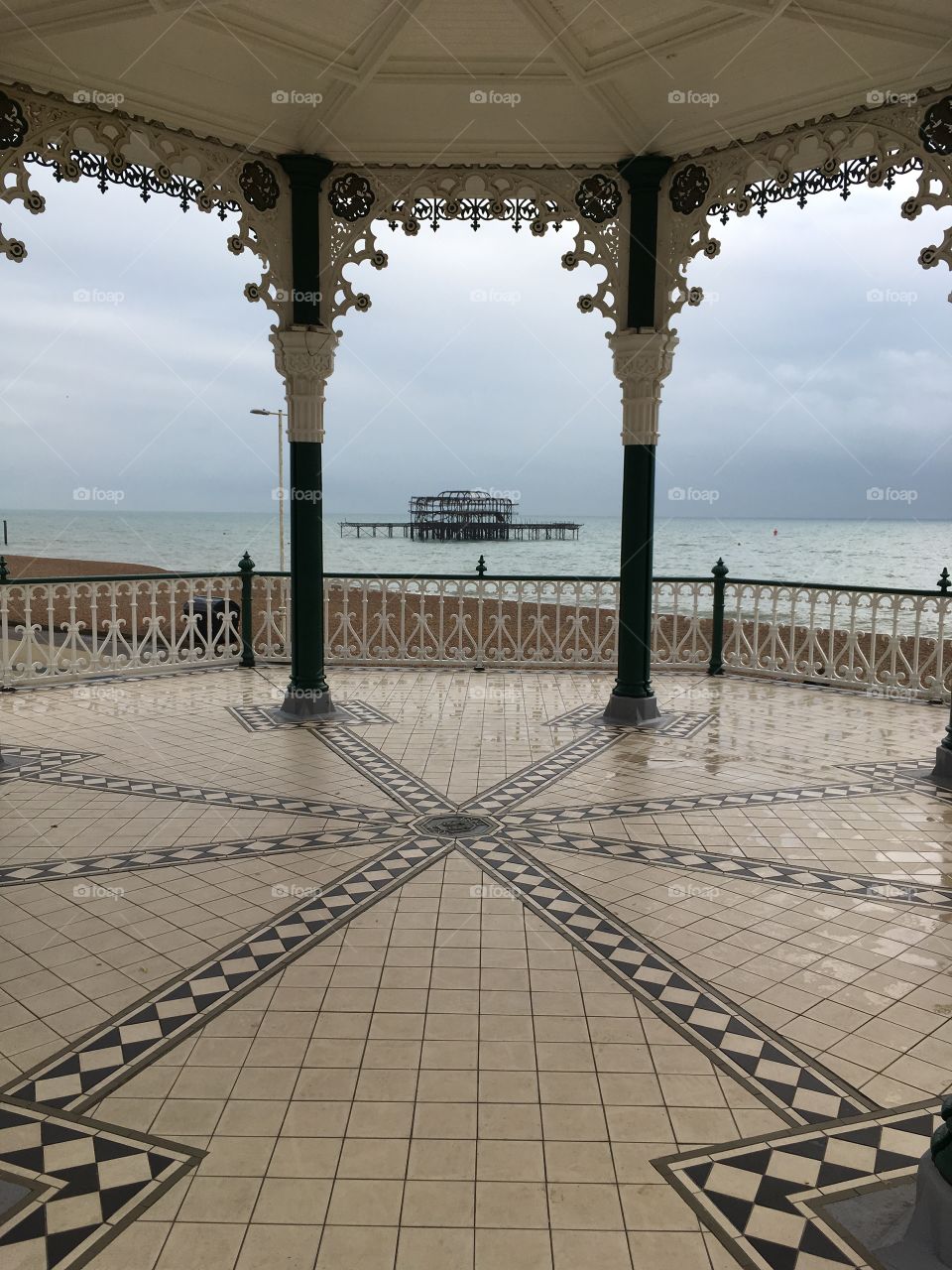 Brighton ruined pier seen from decorative Victorian bandstand with beautiful floor
