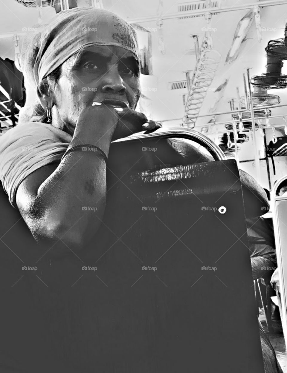 A man sitting on seat of Mumbai local train