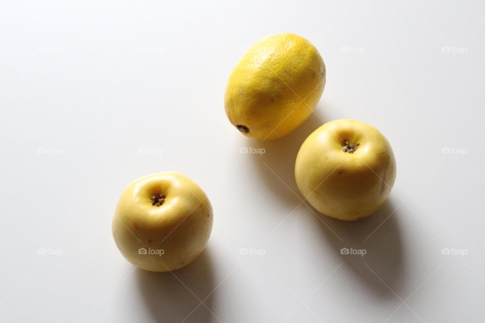 Yellow apples and lemon