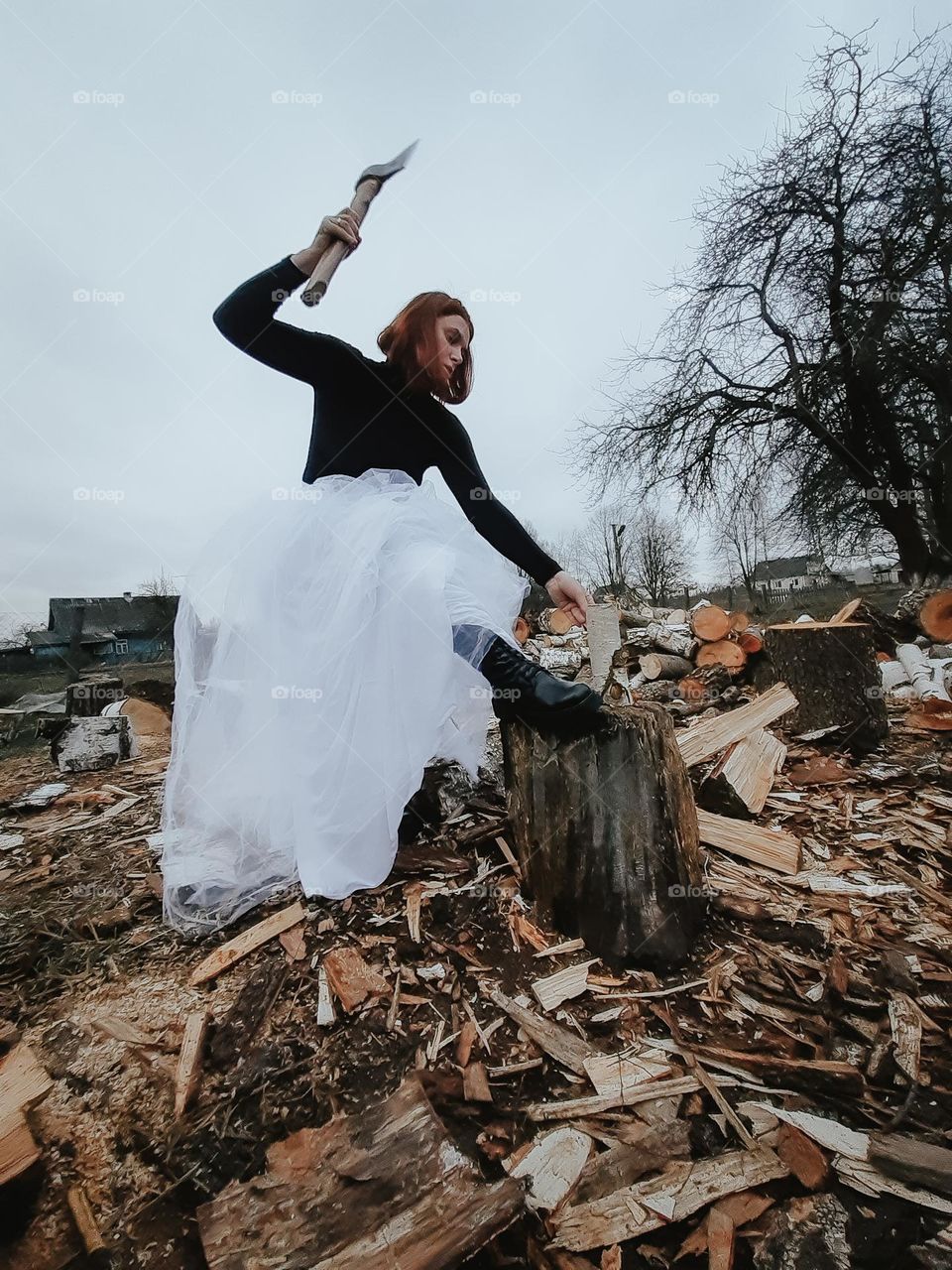An evil girl is chopping wood