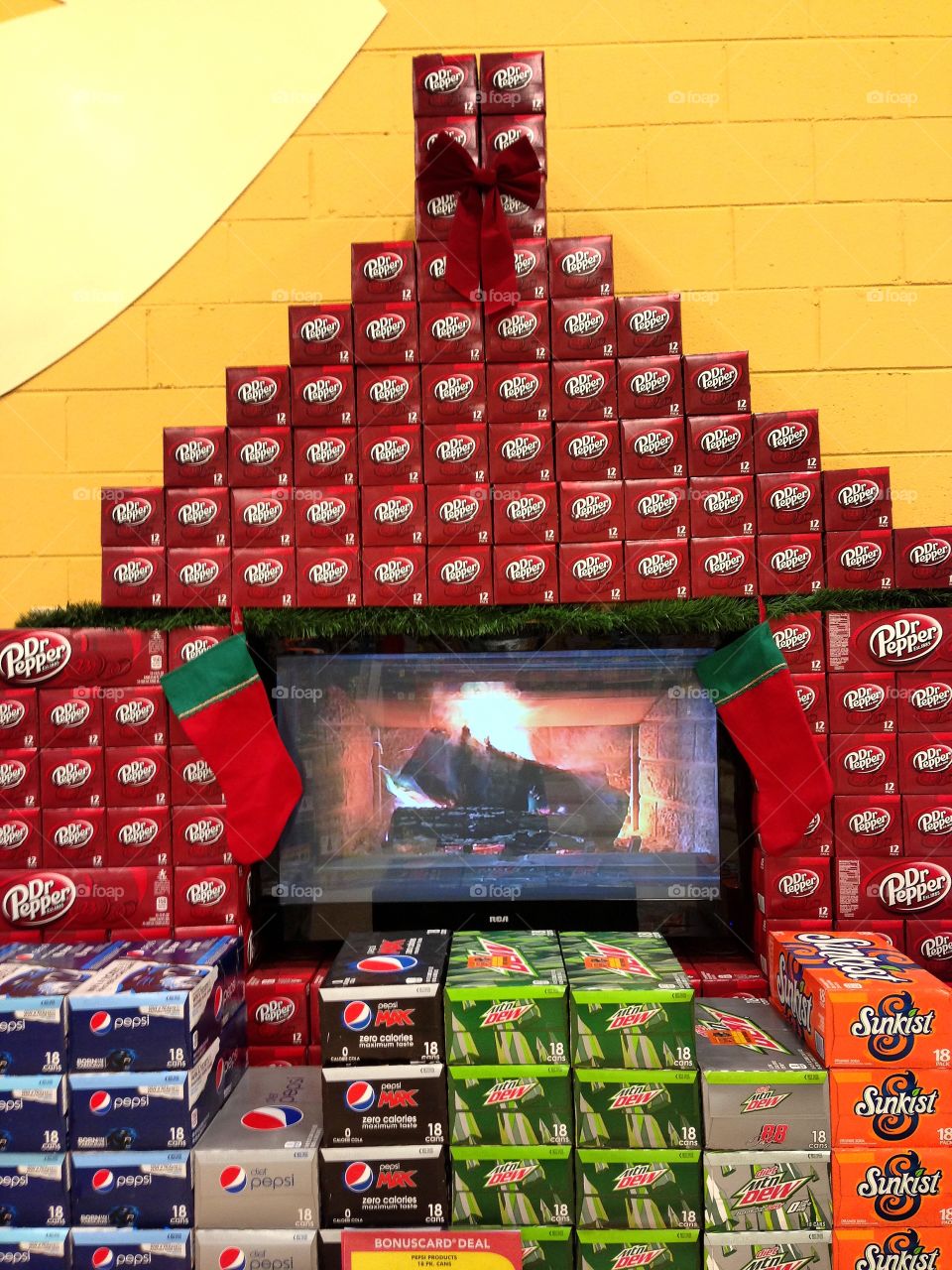A winter themed soda pop display in a grocery store.