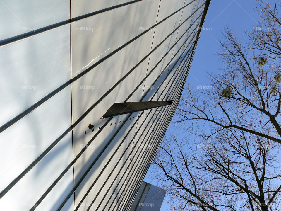 Low angle view of building exterior and trees against sky in Berlin, Germany.