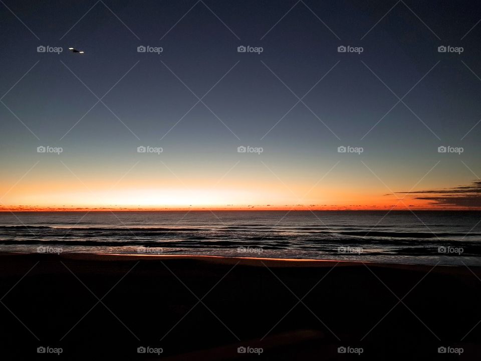 boardwalk sunrise with plane