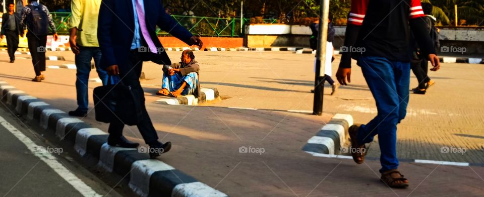 old man setting on street