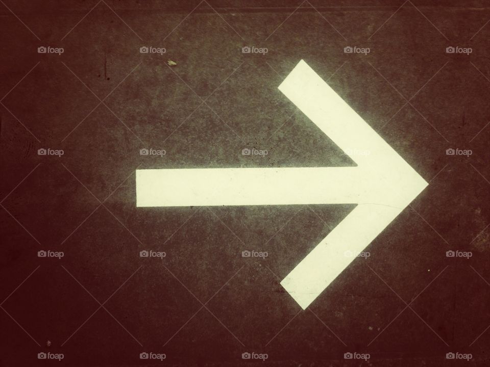 White arrow sign pointing to the right