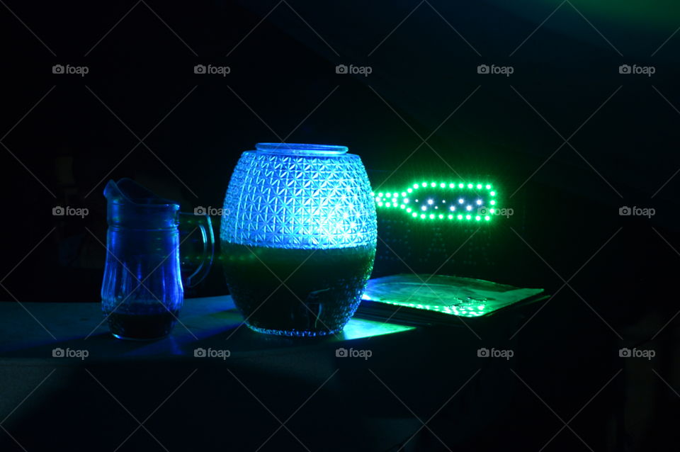 Blue and green neon glow with a moody dark background.