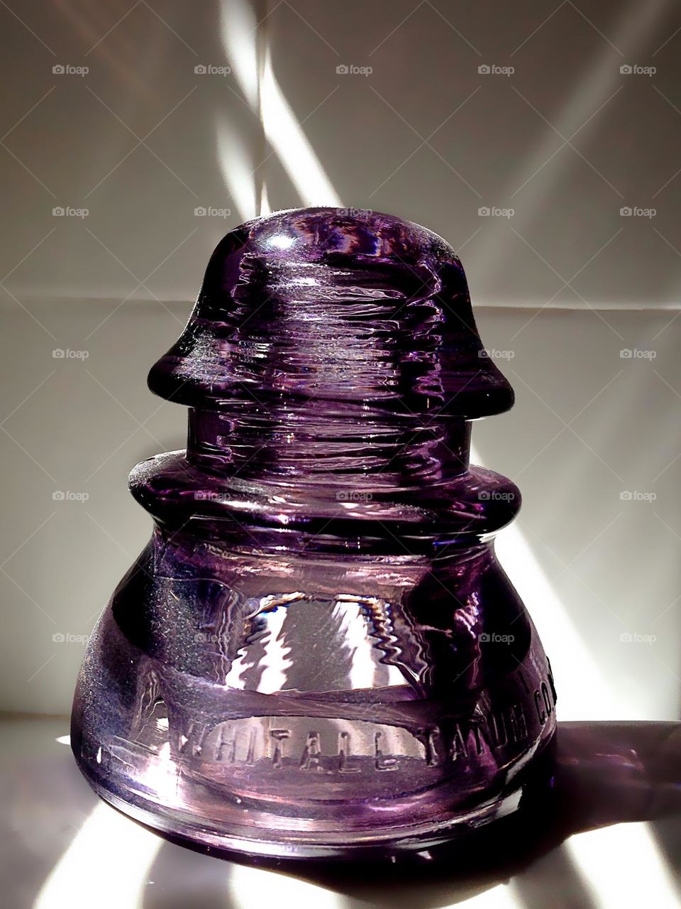 Antique glass electrical insulator purple from sunshine.