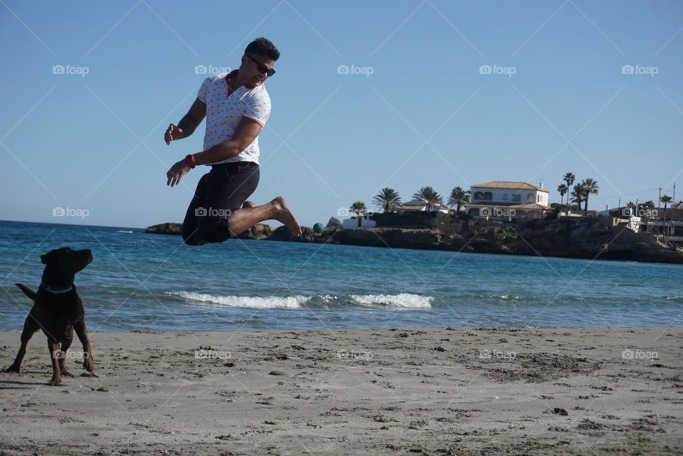 Beach#jump#sea#human#dog#activities#playing