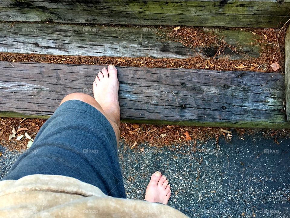 Taking one barefoot step at a time. Steps made of old railroad ties.