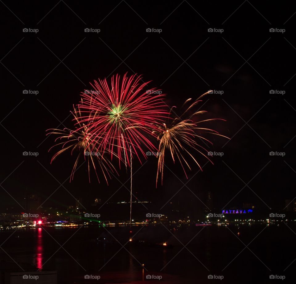 Illuminated firework display during night