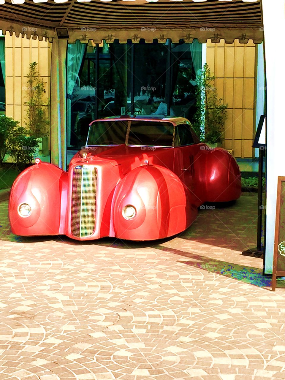 Cadillac in front of a hotel 