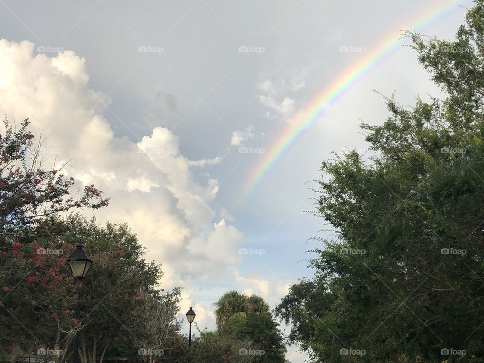 Rainbow in stormy sky at sunset 