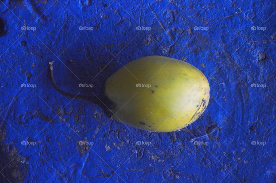 bright photo of yellow fruit on a blue background