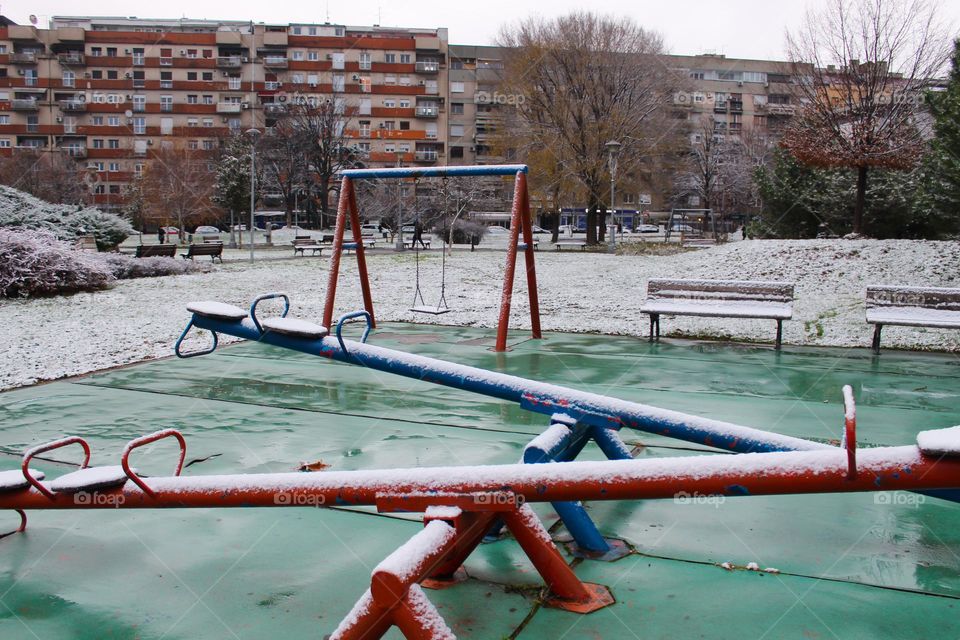 Winter landscape in the city park.  Children's playground covered with snow