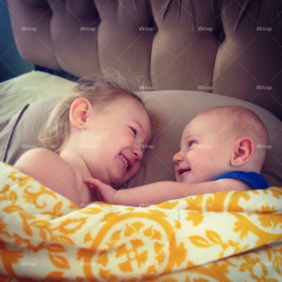 Toddlers laying in bed 