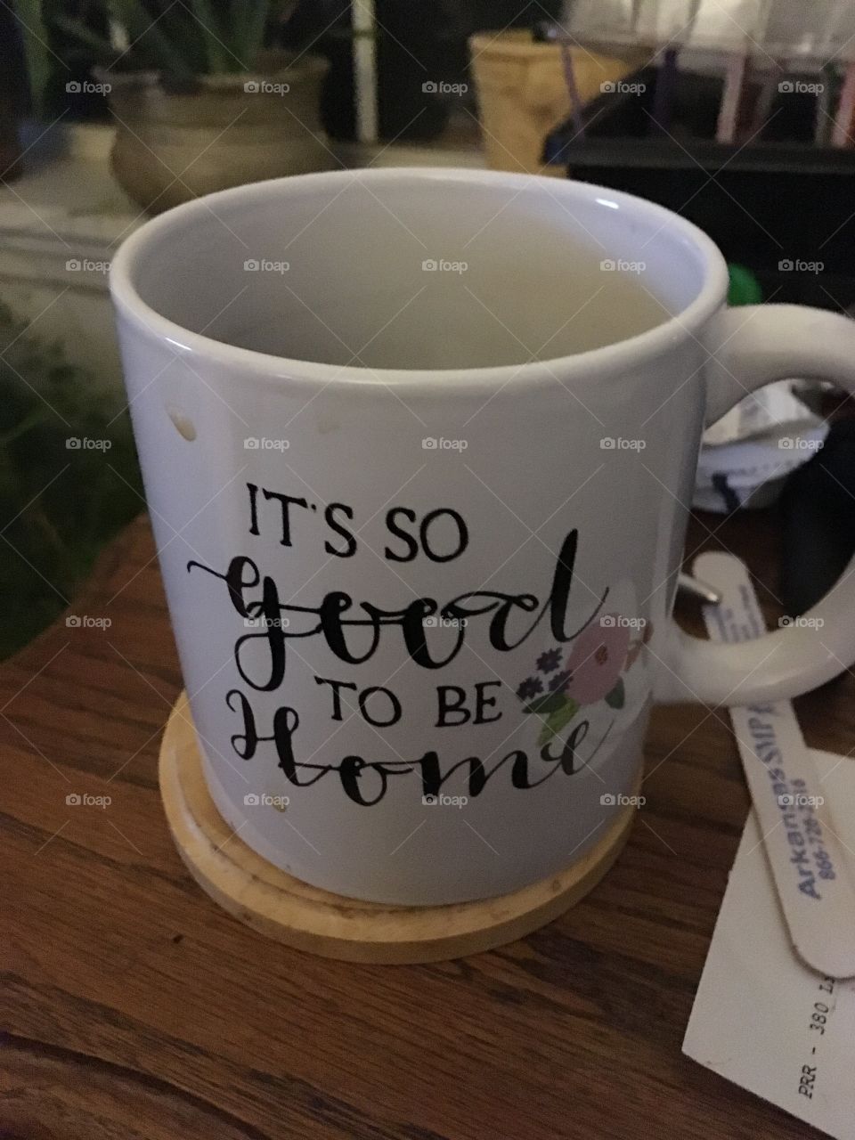 My new favorite coffee cup that says it’s so good to be home. It’s white with black lettering and a pink flower.