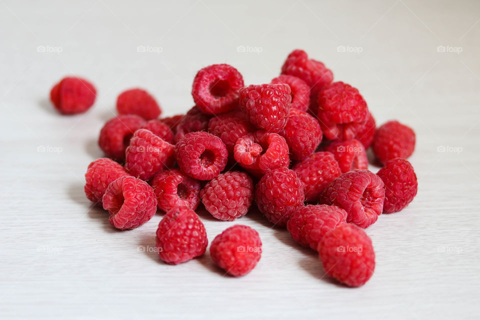 Ripe red raspberries isolated on white