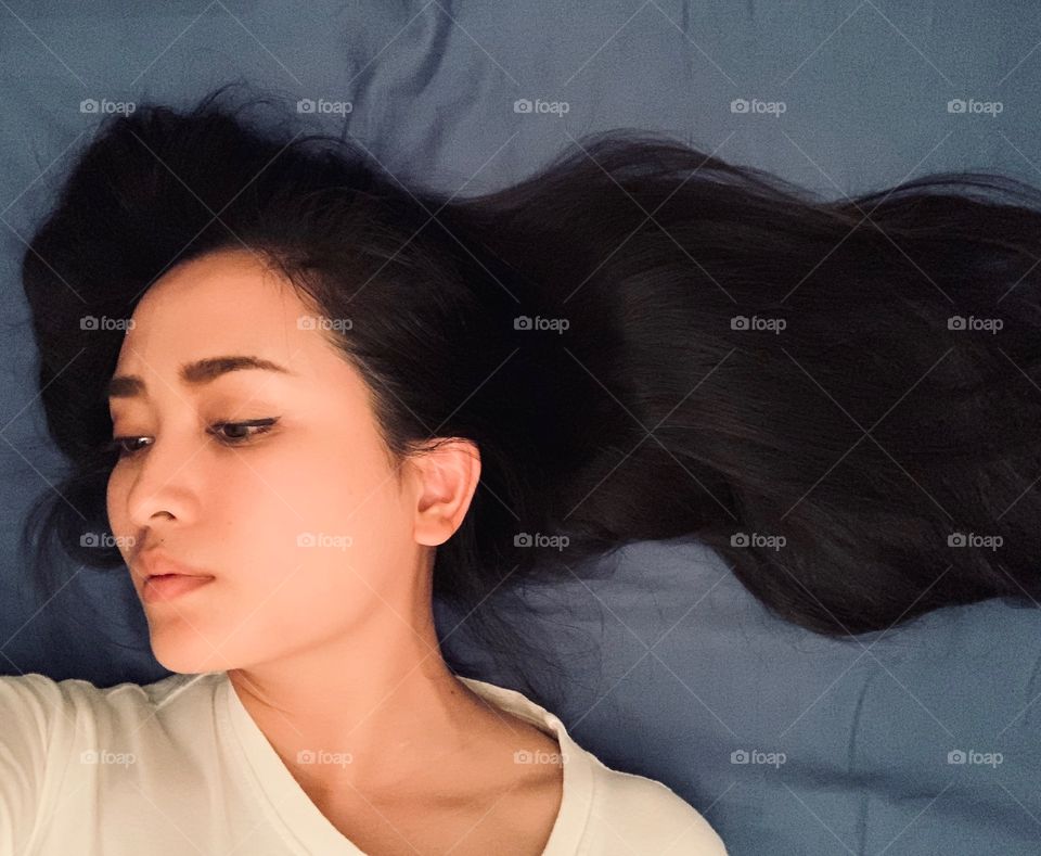 gray tone back drop with black long hair with peaceful emontion