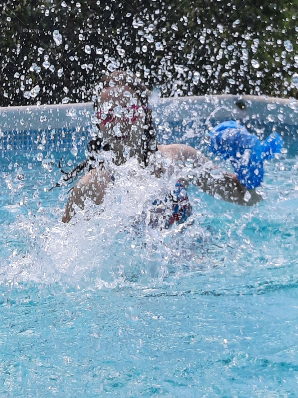 joy of splashng water in swimming pool