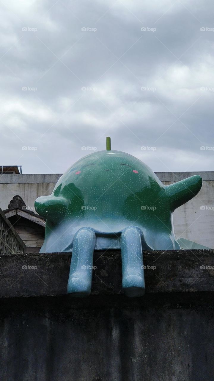 a vertical shot of a metal sculpture on the wall
