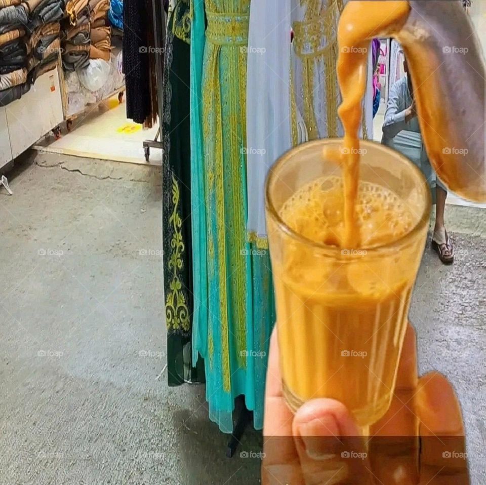 Tea is being enjoyed in a clothes showroom.