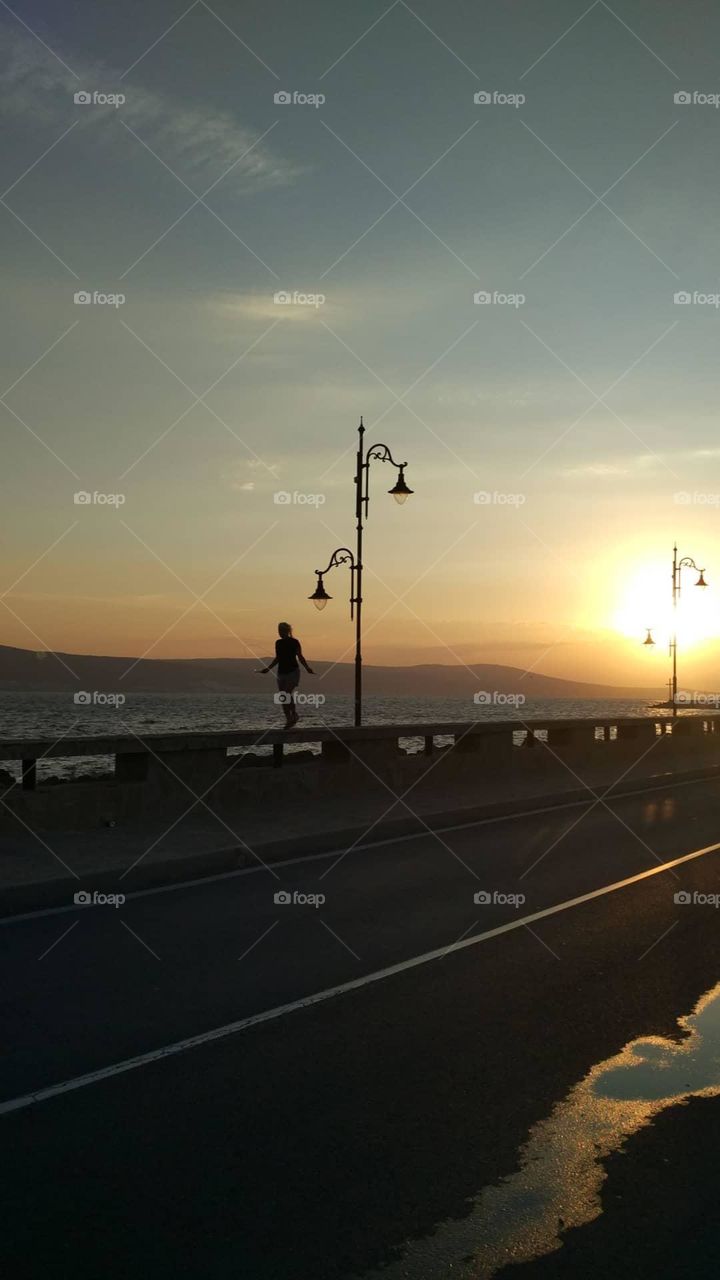 Jumping rope early in the morning on the sea coast