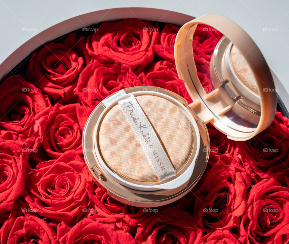 Compact on red roses