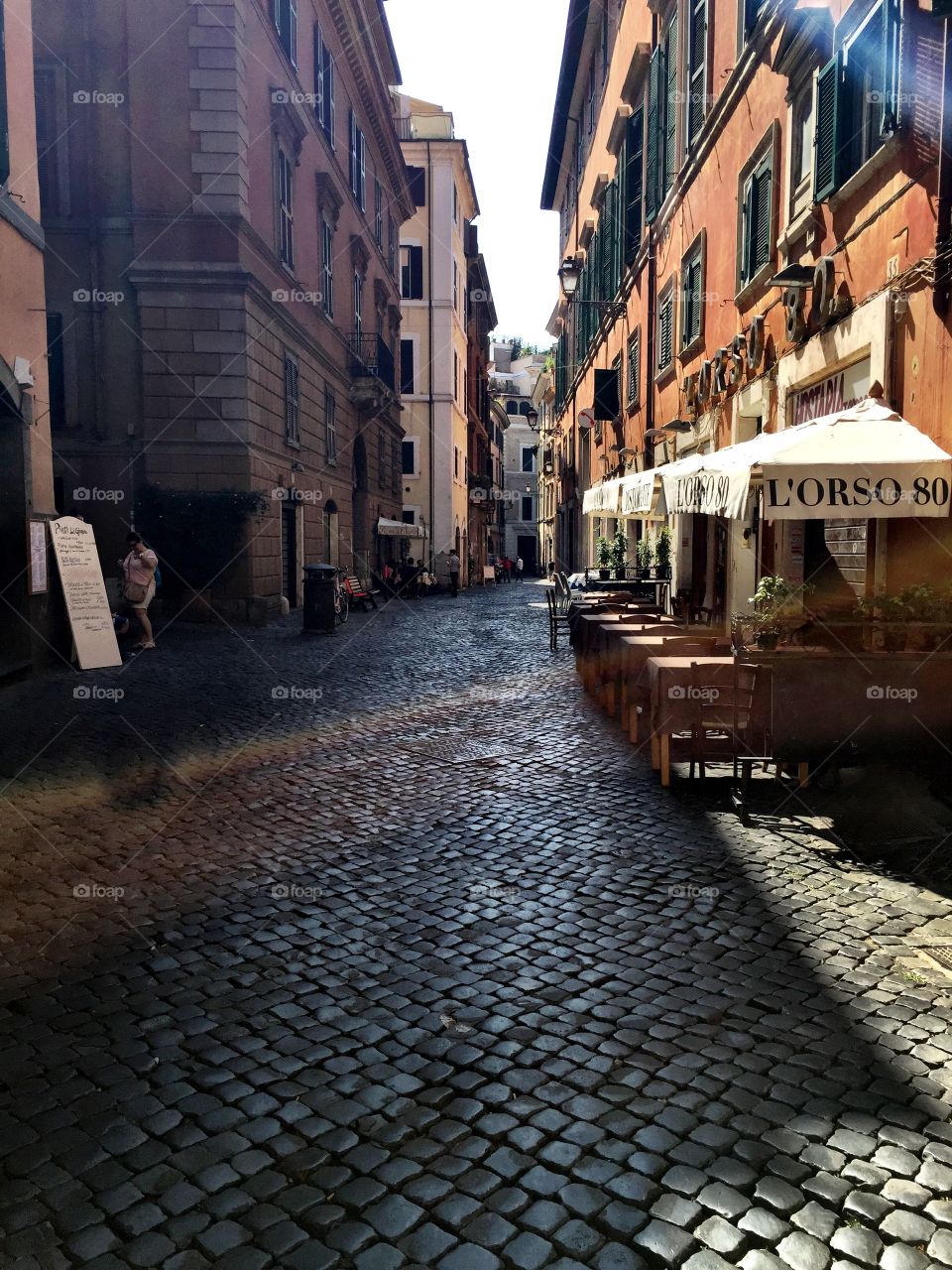 Midday summer in Rome with sweat trickling down our necks as we saunter through the heat but when we take a look up from our poor salty feet below there is true beauty all around us in the cobblestone road to the alley way lined with apartments and small business. 