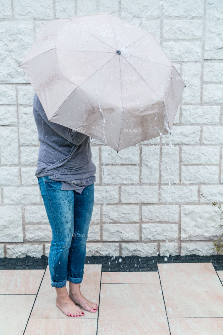 Woman with umbrella . Woman using umbrella to protect herself from rain 