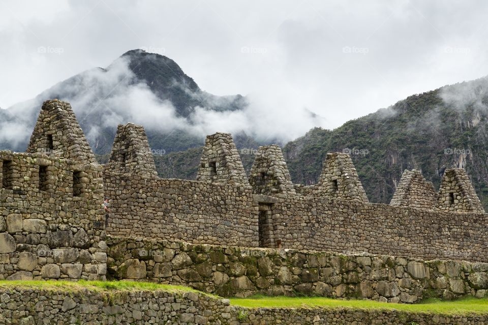 Inca ruins against mountains. Famous Machu Picchu Inca ruins against mountains in the background. Buildings without roof. Stone structure 