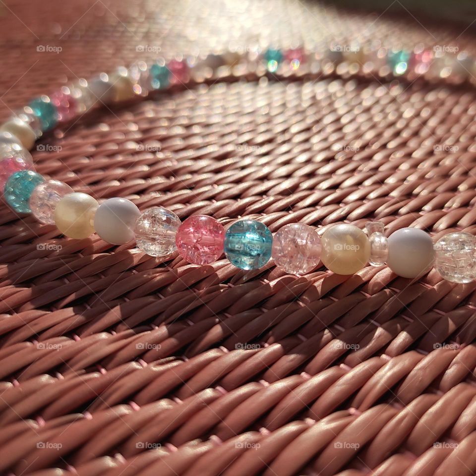 reflection of sunrays on beads and shadow