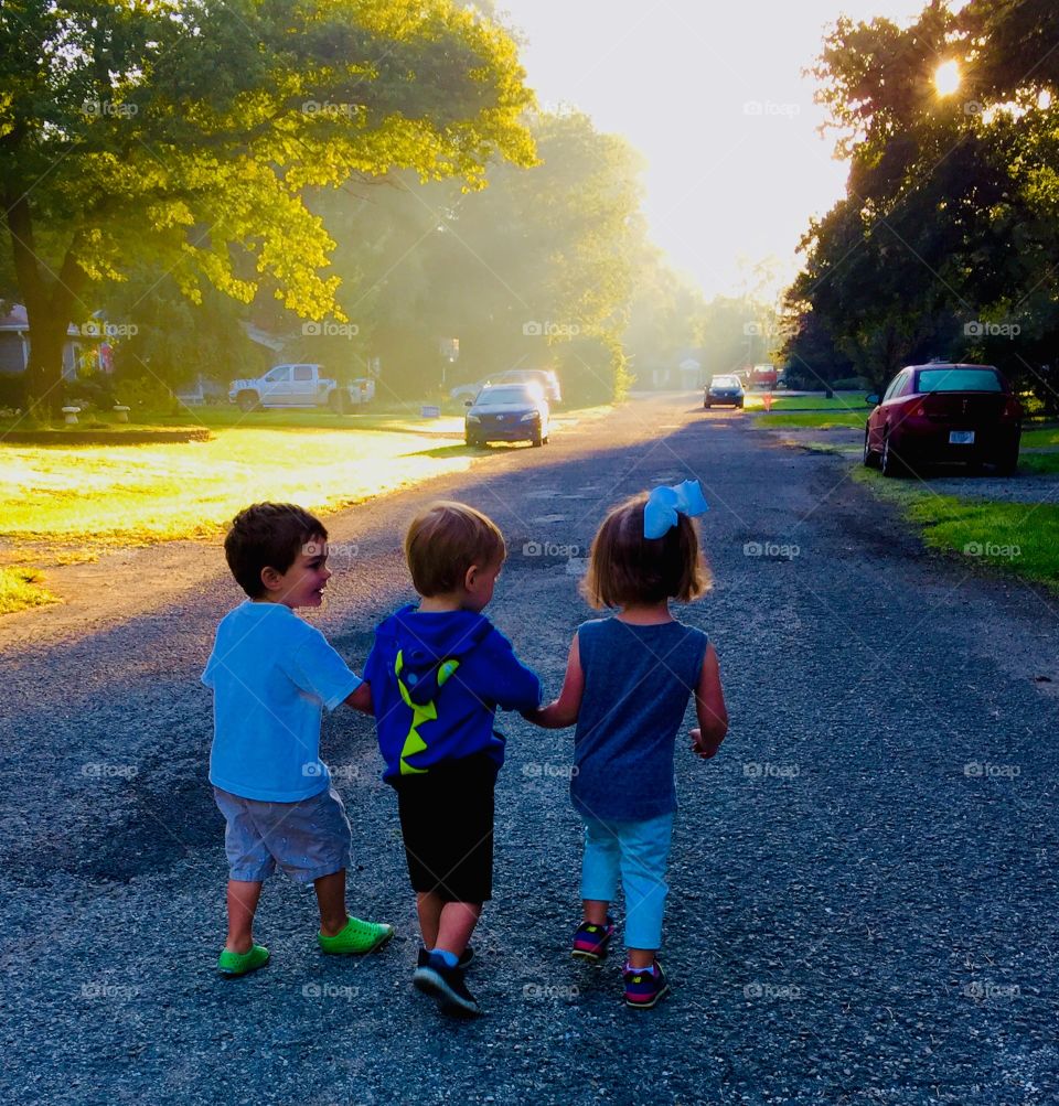Young friends walking down the road in the morning 