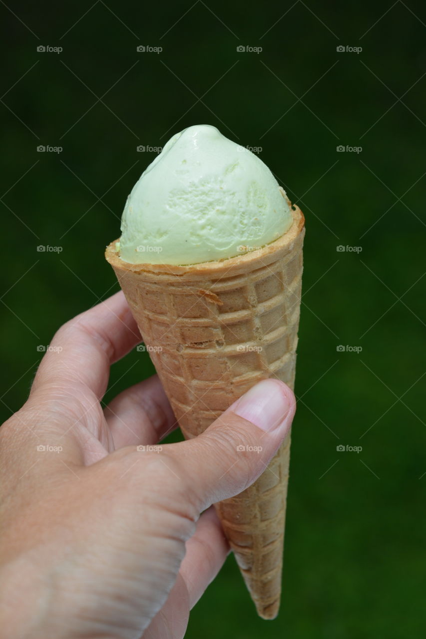 Person's hand holding ice cream