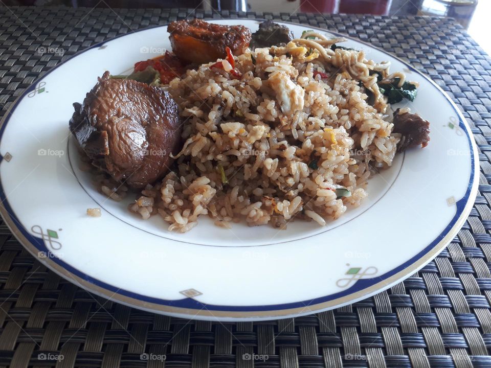 the lunch menu consists of fried rice, chicken, soy sauce and chili sauce