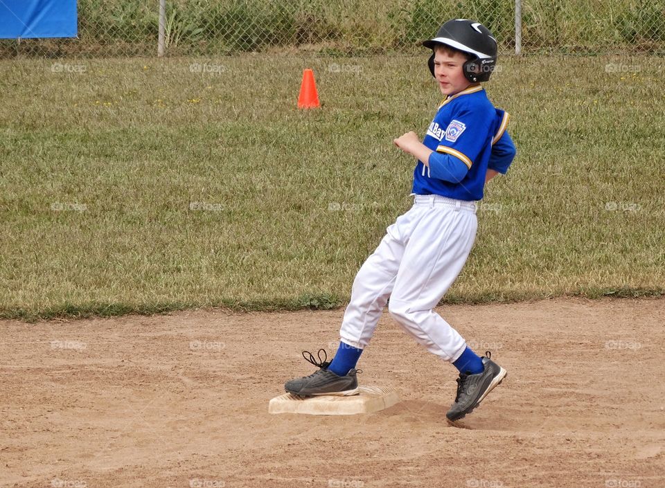 Little League Baseball. Young Baseball Player Stealing Second Base
