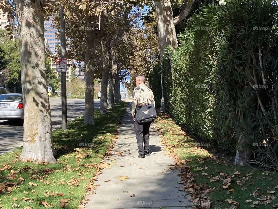 Man walking down a city sidewalk