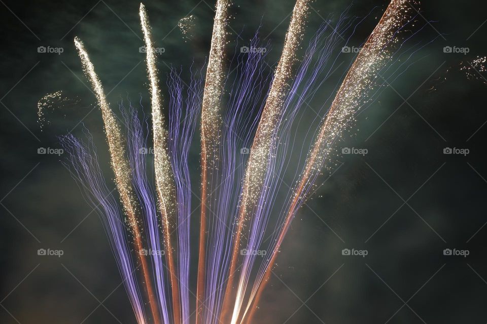 Shining lines of amazing explosions of the fireworks presented in the night sky at the Royal show