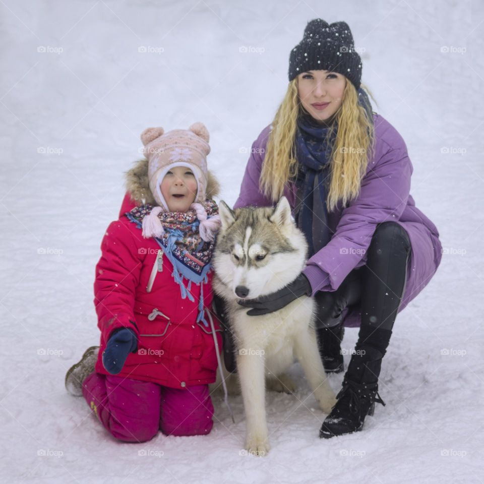 mother with daughter and dog husky