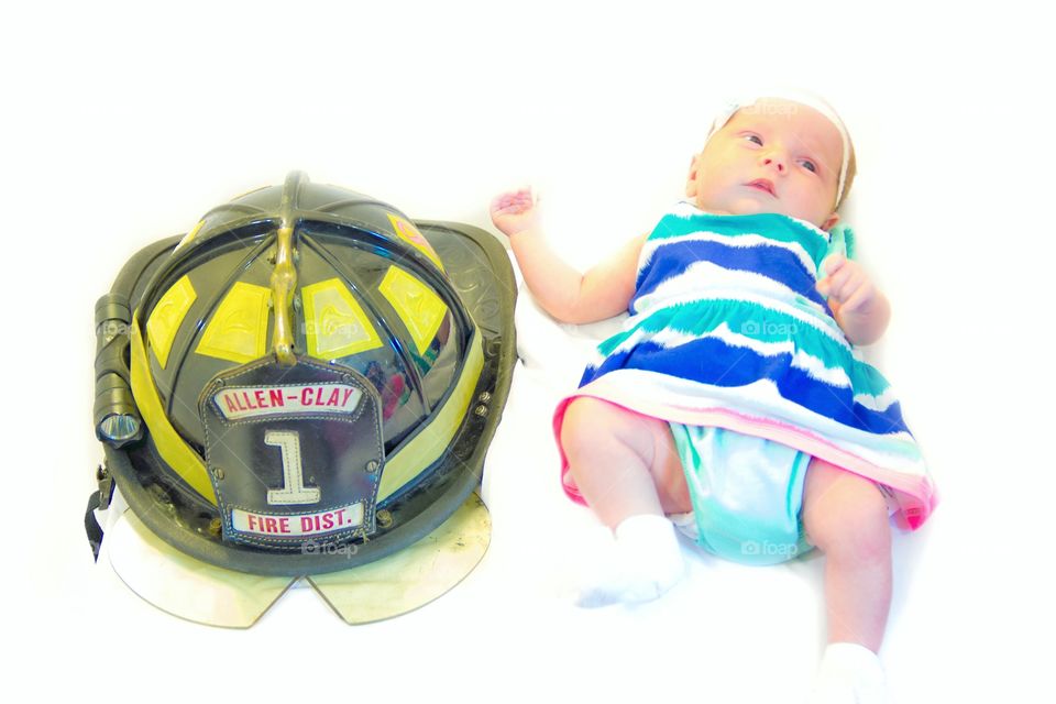 Baby Firefighter. 1 month old daughter getting her photo taken with daddy's helmet