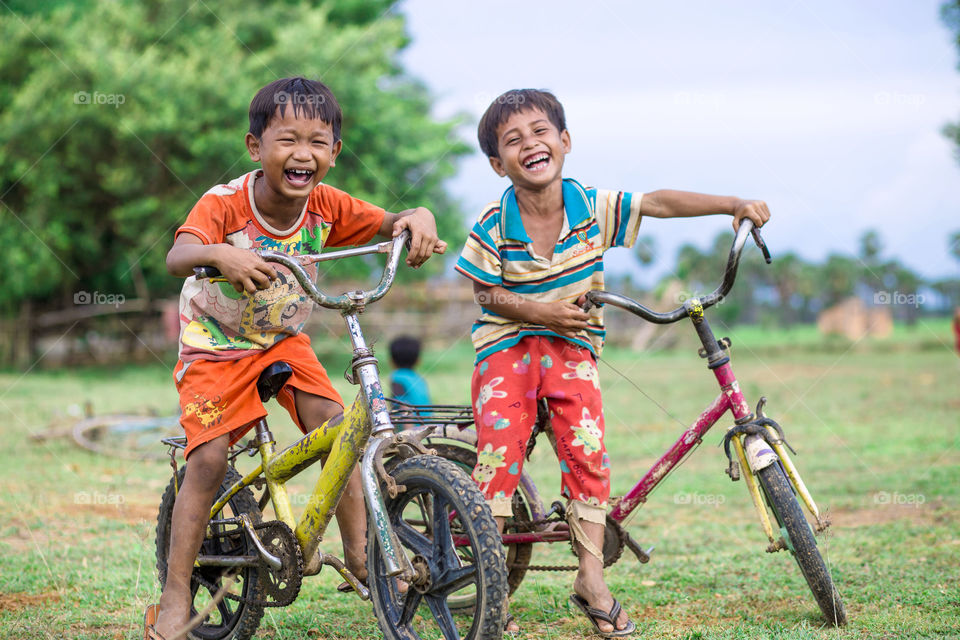 Fun time after a racing . Two friend races a bike cycle after that they enjoy their time together.