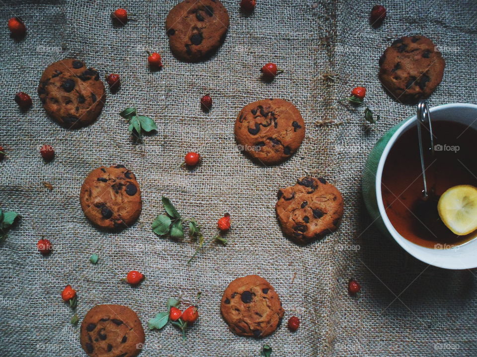 oatmeal cookies with chunks of chocolate and a cup of tea, dessert