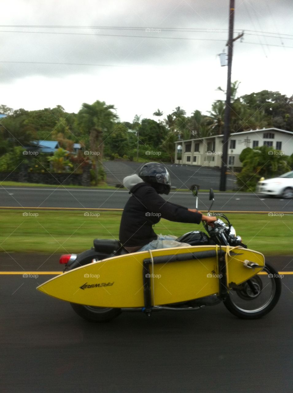 Surfer on a motorcycle in Maui, Hawaii 