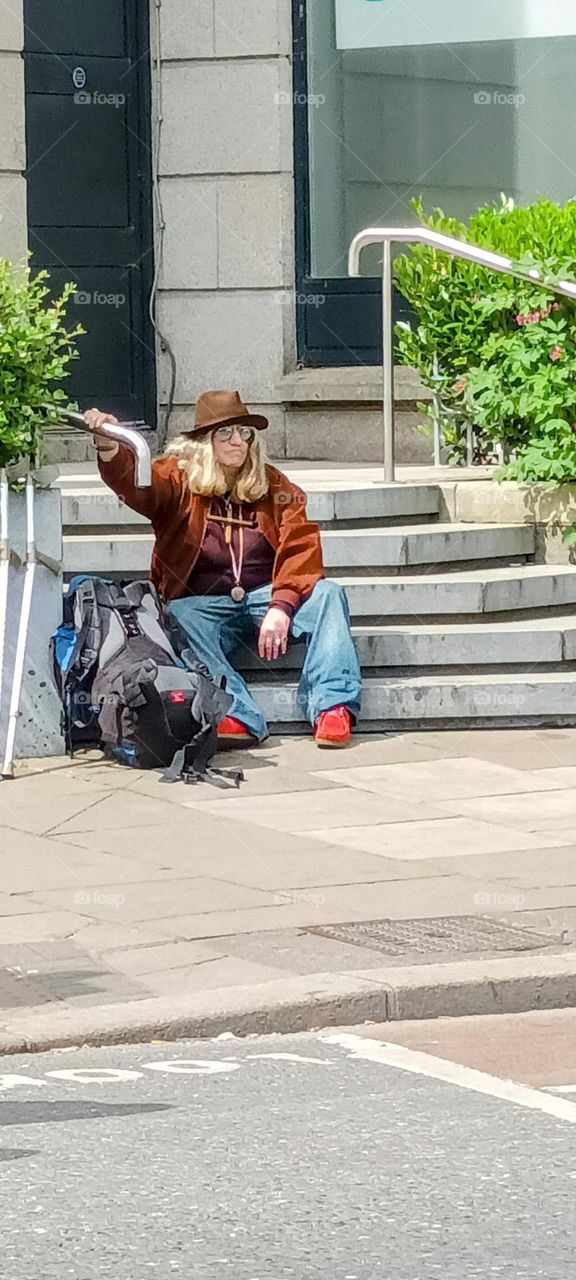 the tired man and his backpack taking a break