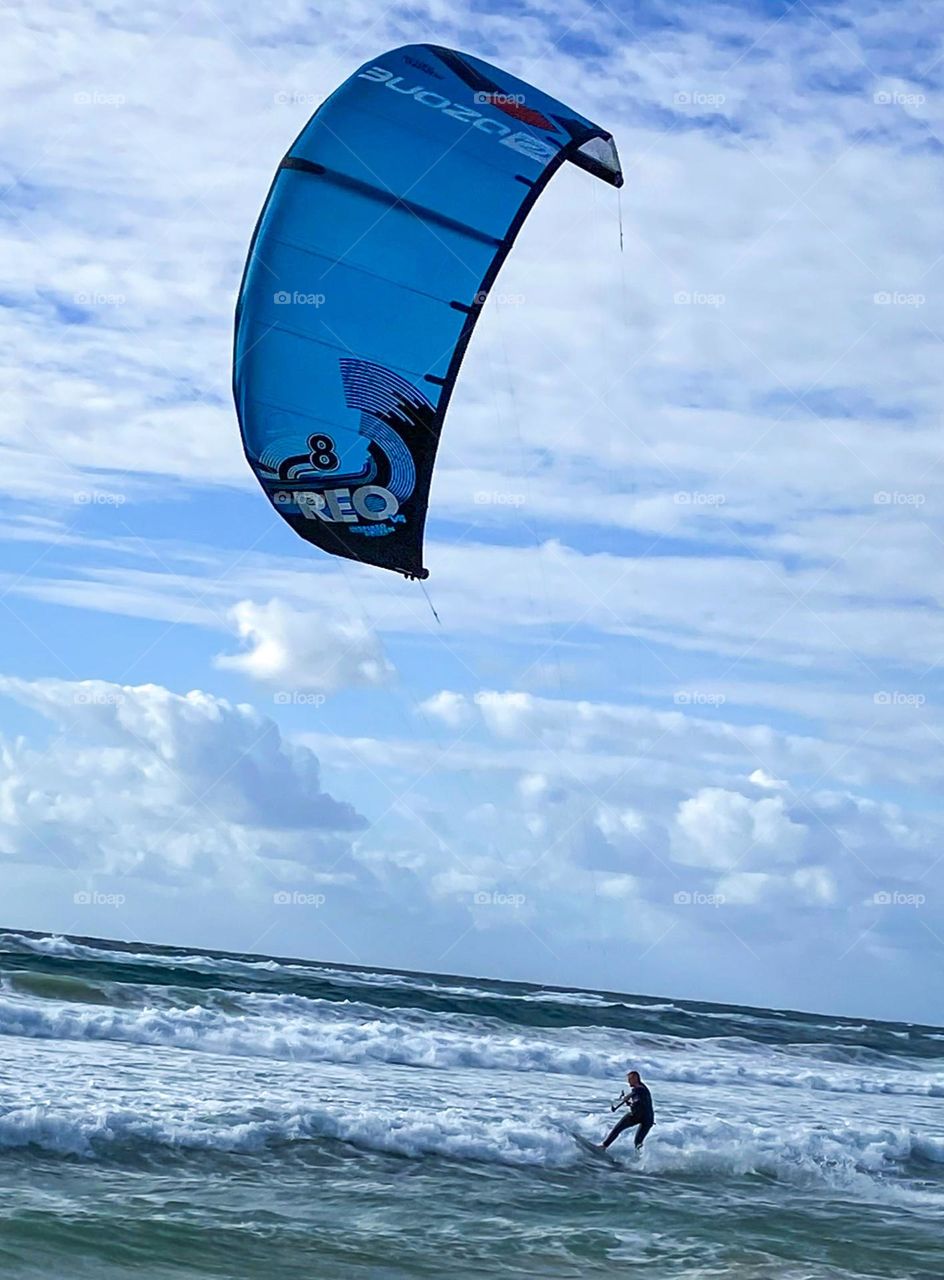 A man kite surfing enjoying summer time