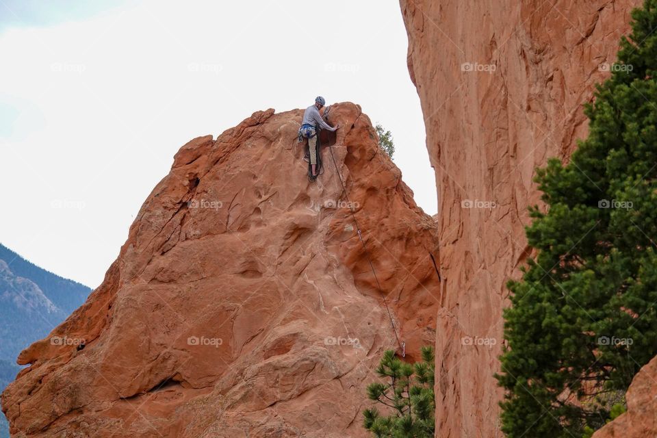 Rock climbing on a tall red rock formation