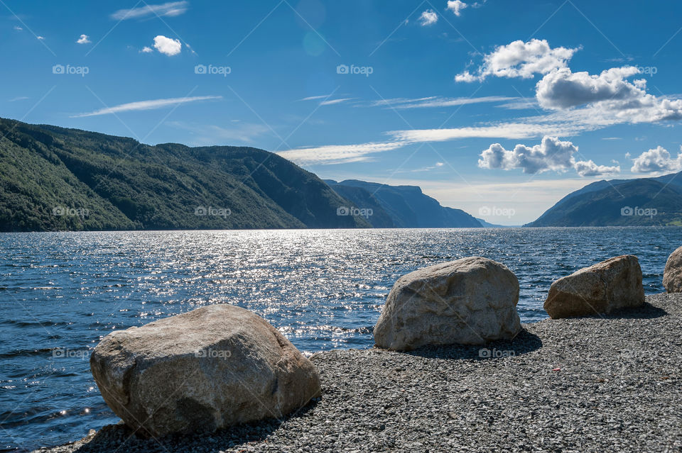 Three stones at the fiord water edge.
