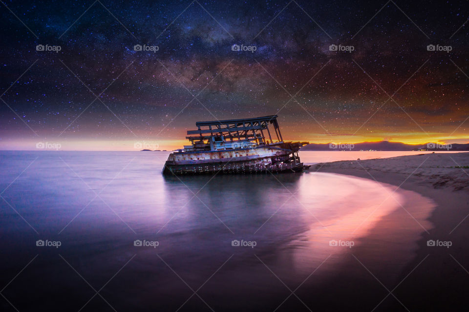 wreck on the beach and milky way