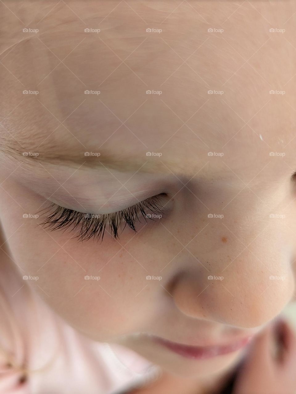 close up, dark, beautiful eyelashes and cute little freckles on a lovely little girl's face